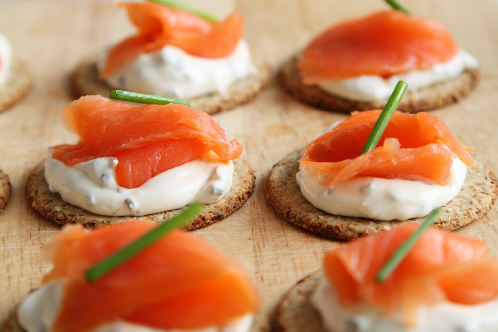 Salmon canapes sitting on a table