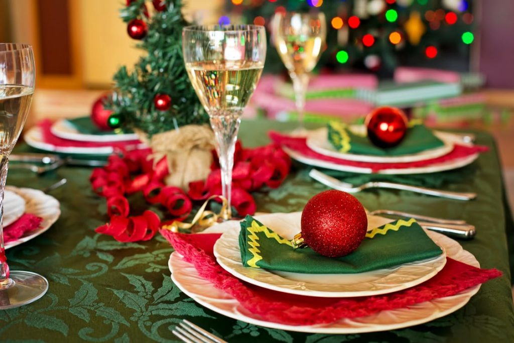 Wine glass on a table decorated with christmas items