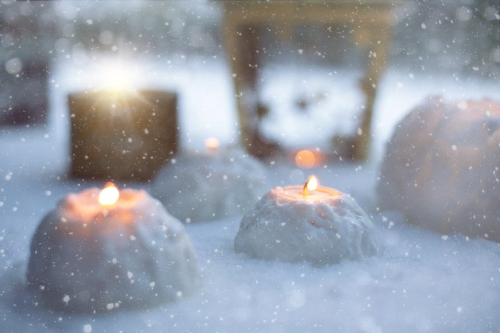 Candles lit in the snow