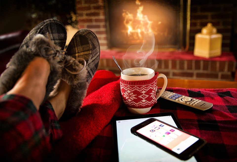 Slippers and hot drink in front of a fire