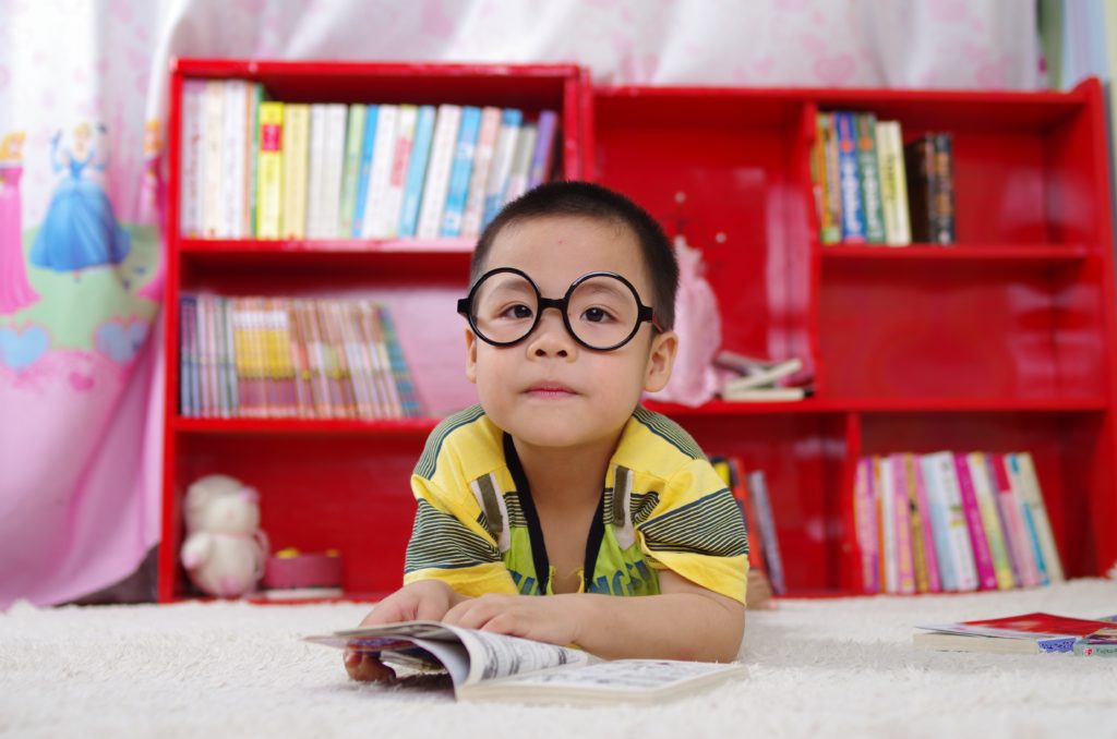 Child in large round glasses