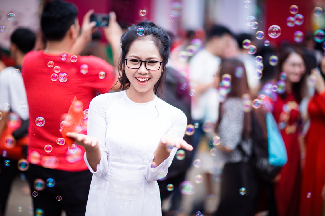 Woman standing amongst bubbles