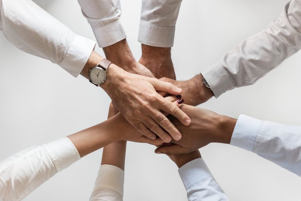 People piling hands on top of one another