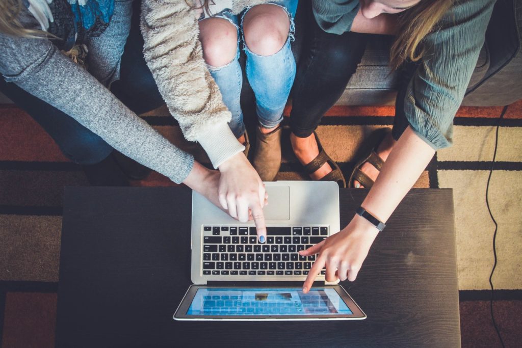 Group of people working on a laptop