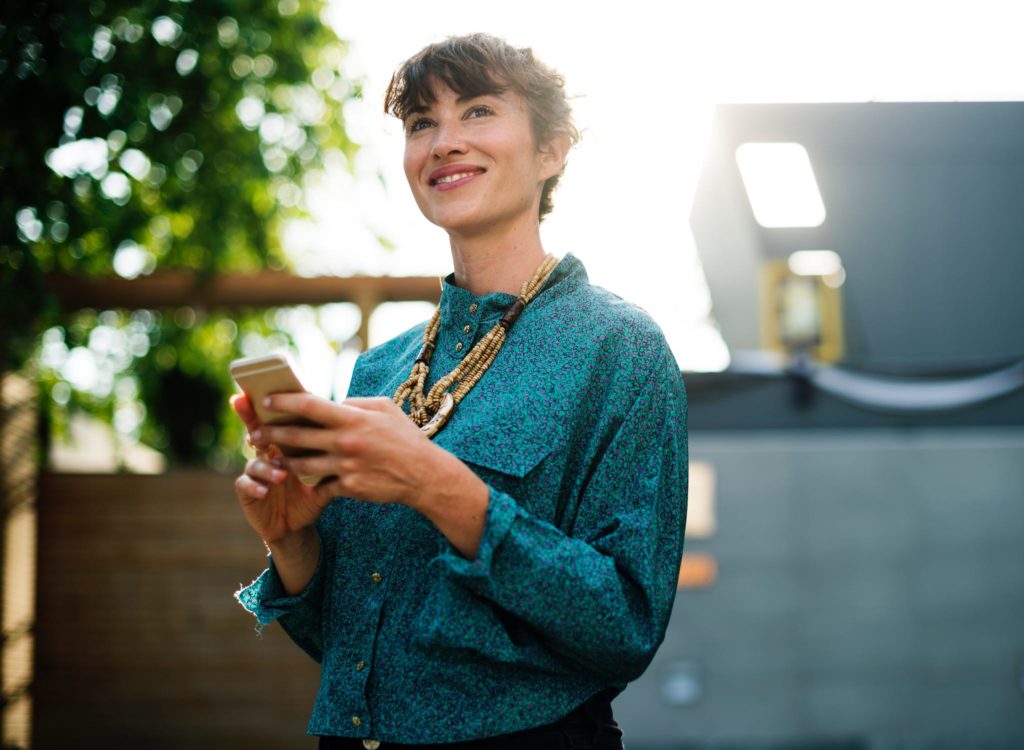 Smiling woman on her smartphone