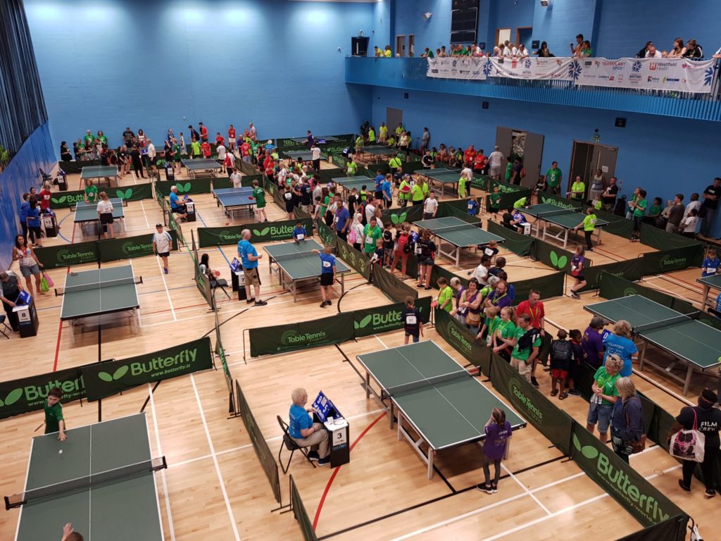 Many people playing table tennis