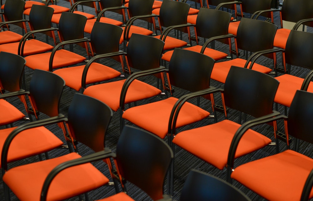 Chairs arranged next to one another, theatre style