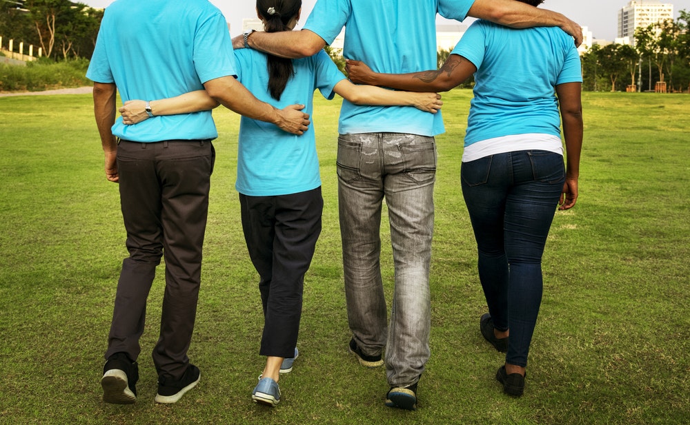 Group of people linking arms