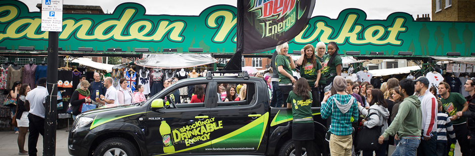 People crowding round a car