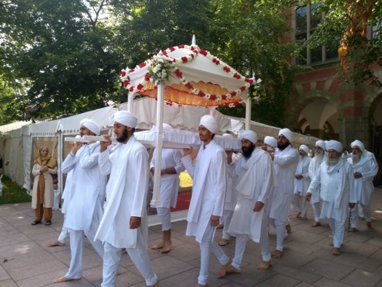 The camopy leaving Chancellor's Court to collect the scriptures
