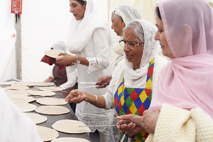 Sikh women making chapattis