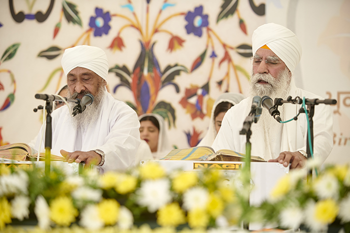 Sikh men reading prayer