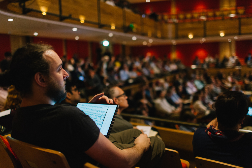 Man sitting in the Bramall taking notes on an ipad