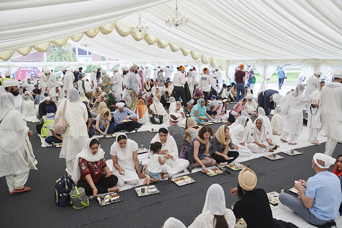 People enjoying food in the langar