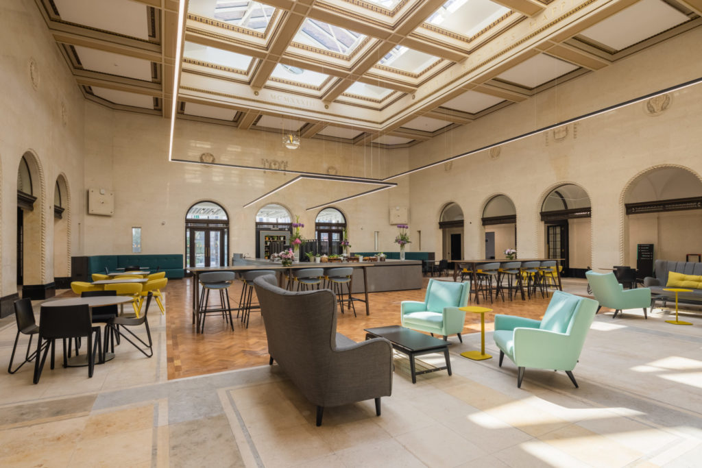 Large bright room with boutique chairs and coffee counter. Fellows Coffee Shop at The Exchange.
